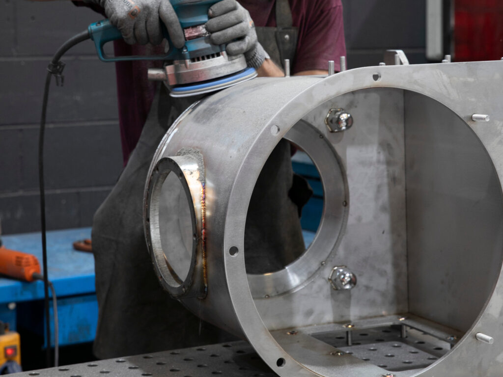 R&G Metal Shaping's technical department polishes a cylindrical stainless steel structure with electric polishing to achieve a high industrial quality finish.